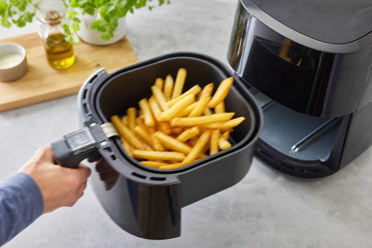 Secouer le panier de l'Air Fryer pour retourner les frites en cours de cuisson